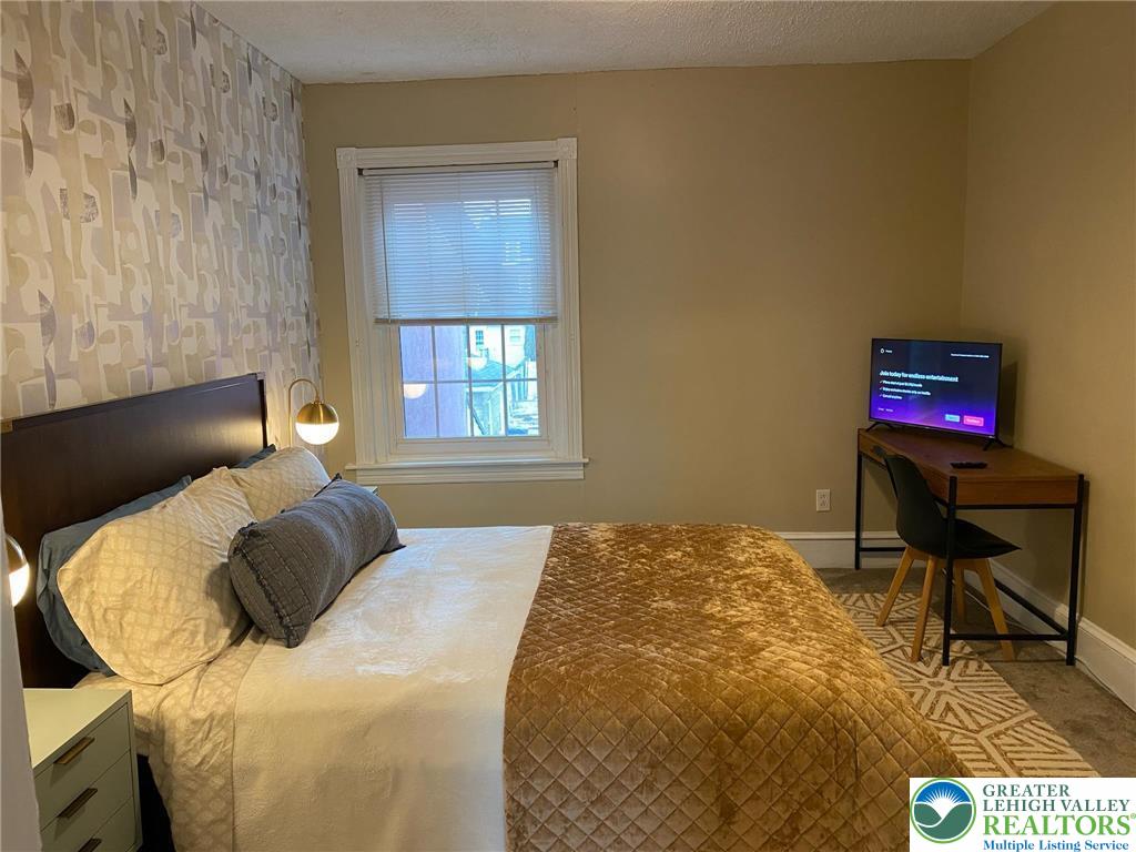 37 Evergreen Street Nazareth, PA 18064 - Photo 15 of 32 a bedroom with a bed and a chair
