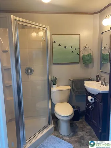 a bathroom with a toilet a sink and shower