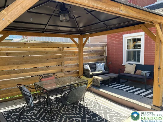 a backyard of a house with barbeque oven table and chairs