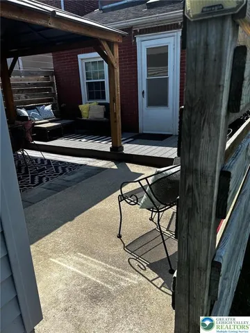 a living room with chairs and a stove