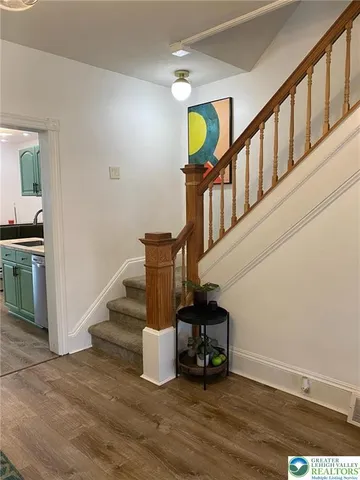 a view of entryway and hall with wooden floor