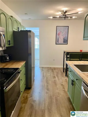 a kitchen with granite countertop a stove and a refrigerator