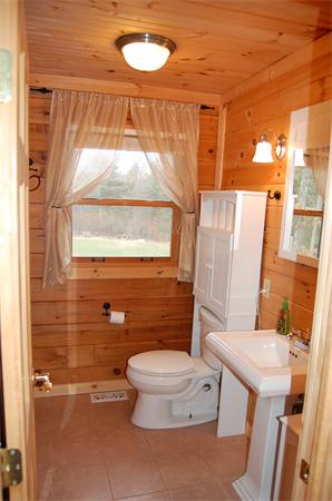 61 Coffey Hill Road Ware, MA 01082 - Photo 9 of 26 a bathroom with a toilet a sink and a window