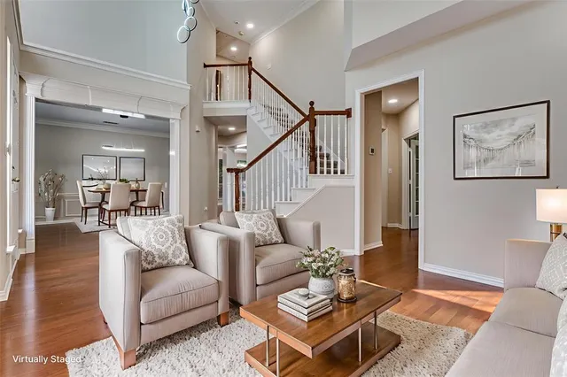 a living room with furniture a wooden floor and a chandelier
