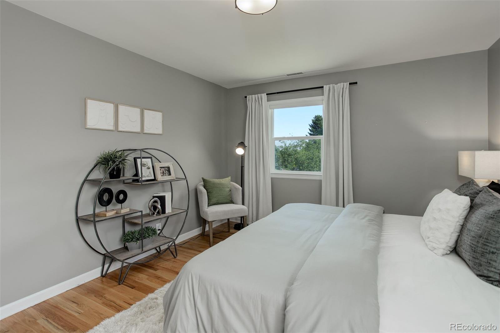 1309 West Ridge Road Littleton, CO 80120 - Photo 15 of 40 a bedroom with a bed a mirror and a window