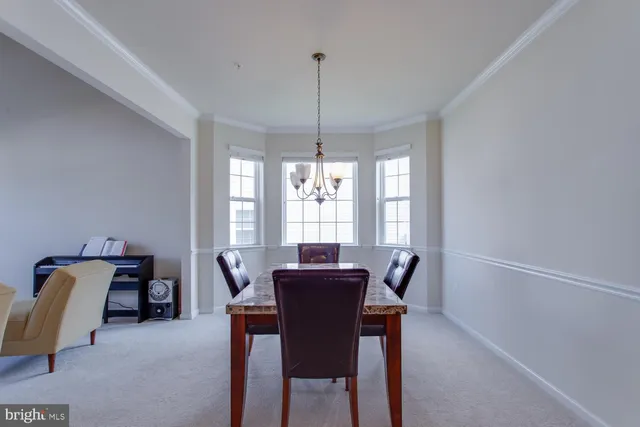 a view of a dining room with furniture and window