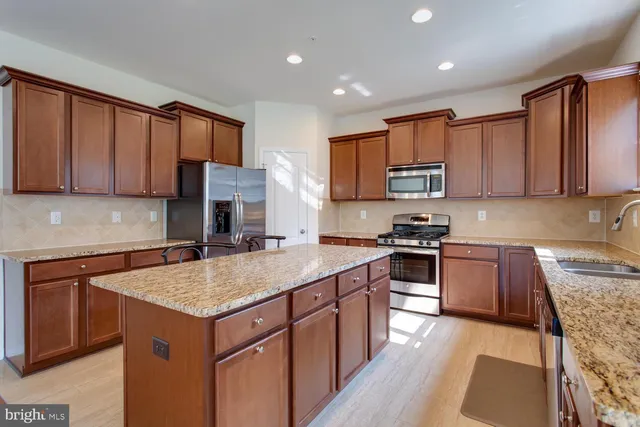 a kitchen with a stove sink microwave and cabinets