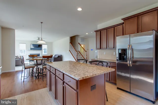 a kitchen with a stove a refrigerator and a dining table
