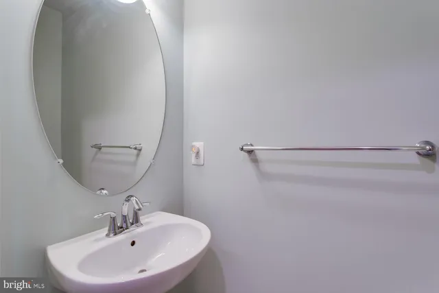 a bathroom with a sink a mirror and vanity