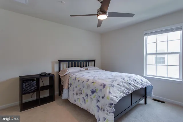a bedroom with furniture and a window