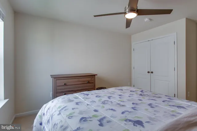 a bathroom with a sink a toilet a mirror and shower curtain