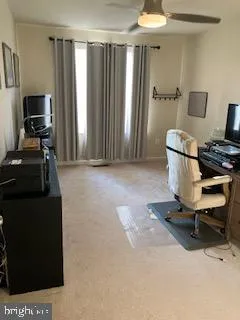 a bedroom with bed tv and window