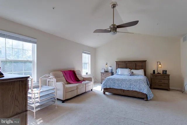 a spacious bathroom with a tub sink and mirror