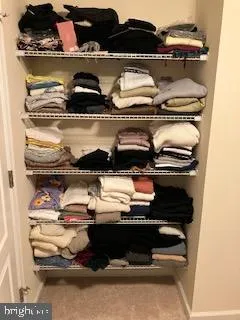 a large kitchen with stainless steel appliances granite countertop a large stove top oven a large island with wooden cabinets and floor