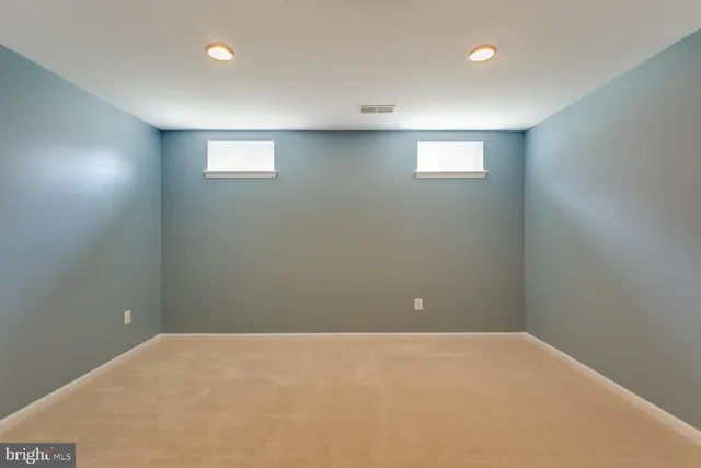 a front view of a house with a garden and yard