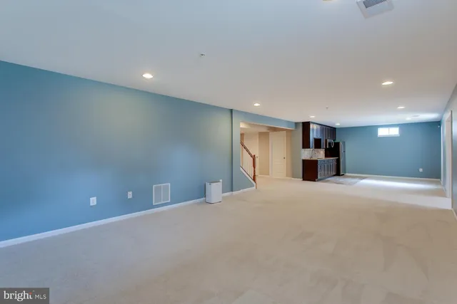 a front view of a house with a garden and lake view