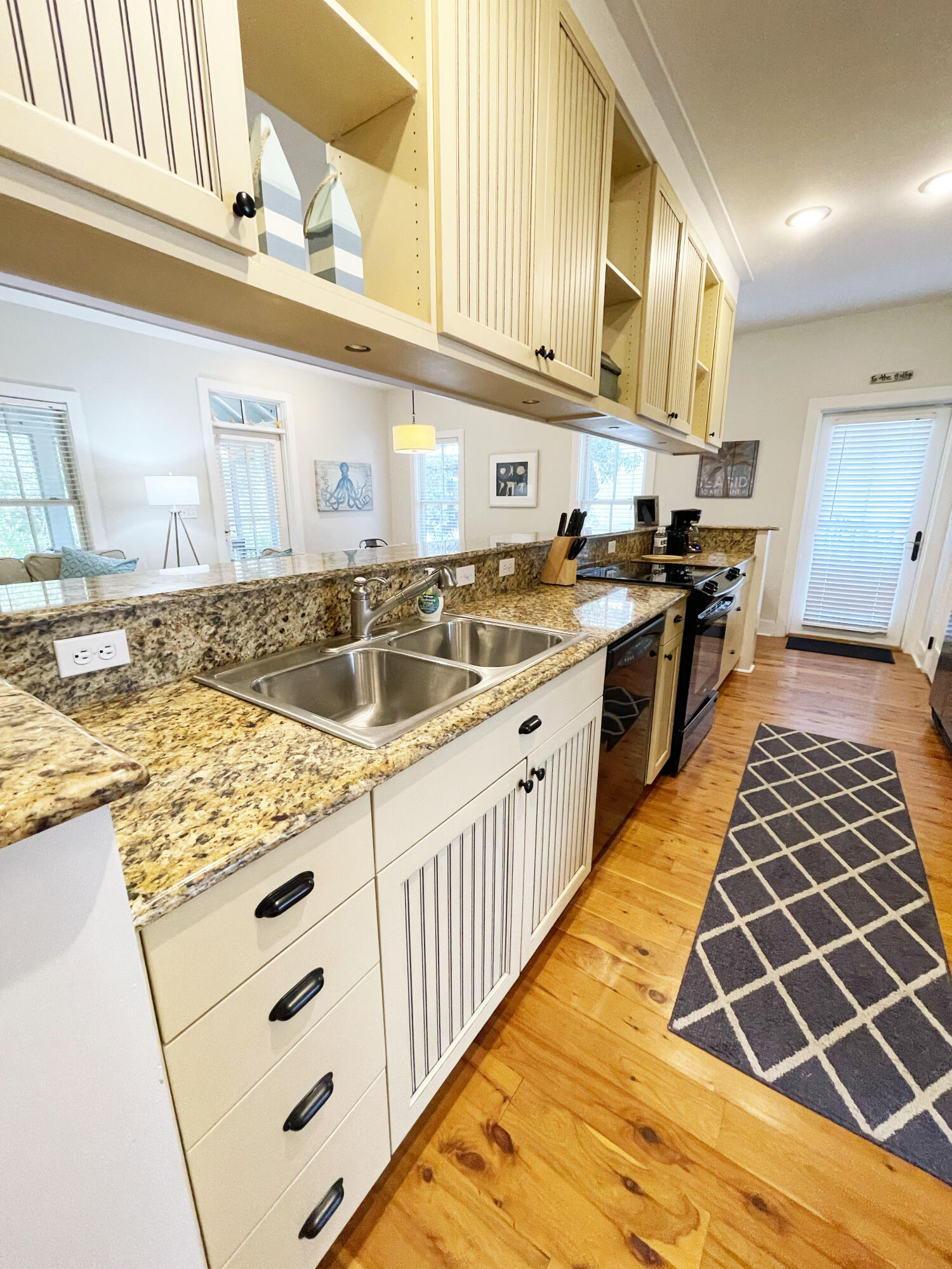 29 Olivia Lane Seacrest, FL 32461 - Photo 19 of 28 a kitchen with stainless steel appliances granite countertop a sink and cabinets