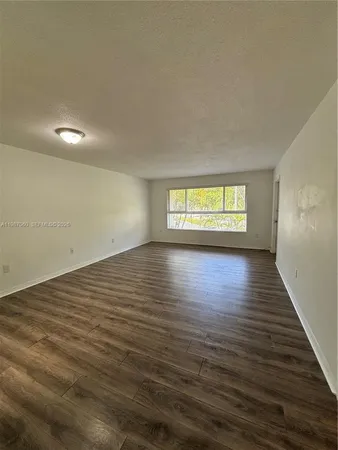 a view of room window and wooden floor