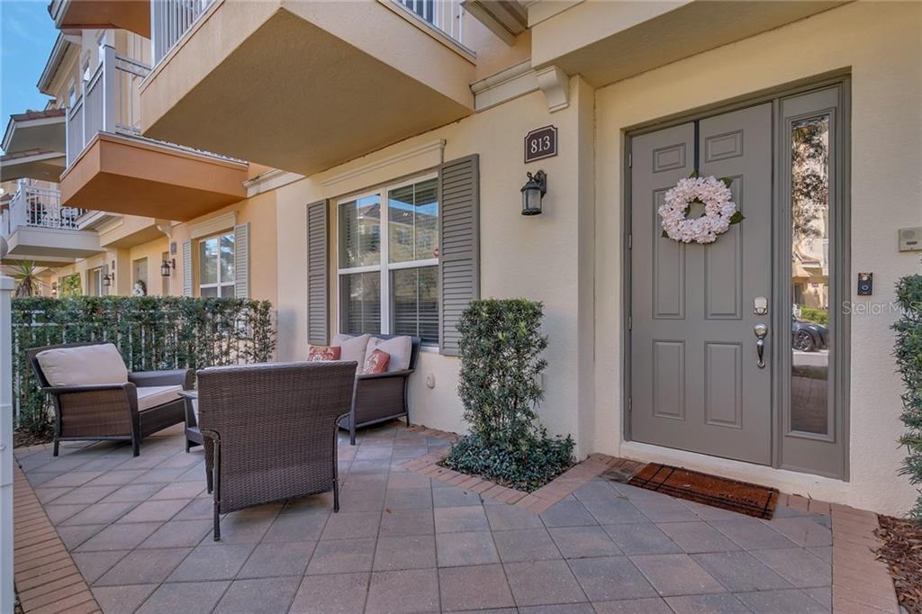 Front Entrance with gate to extra parking through patio. The balcony above is off the family room area of this home and located on the main floor. Check out the 3d matterport 360 walk through for full tour.