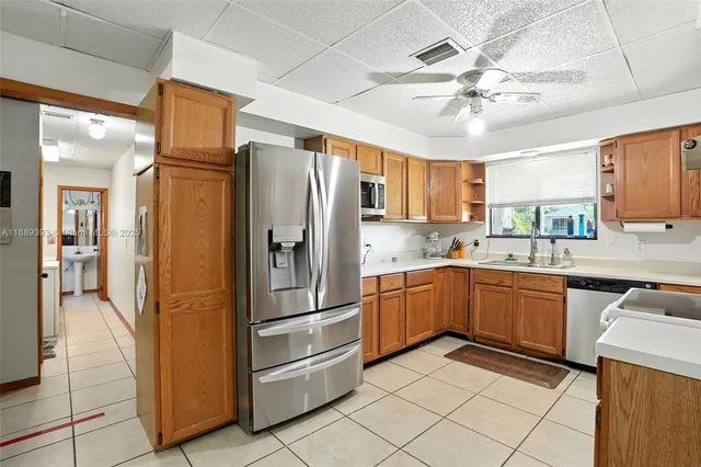 a kitchen with stainless steel appliances granite countertop a refrigerator microwave and sink