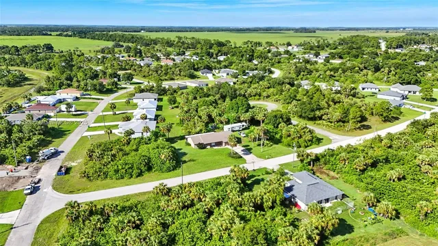 an aerial view of a house with yard and street view