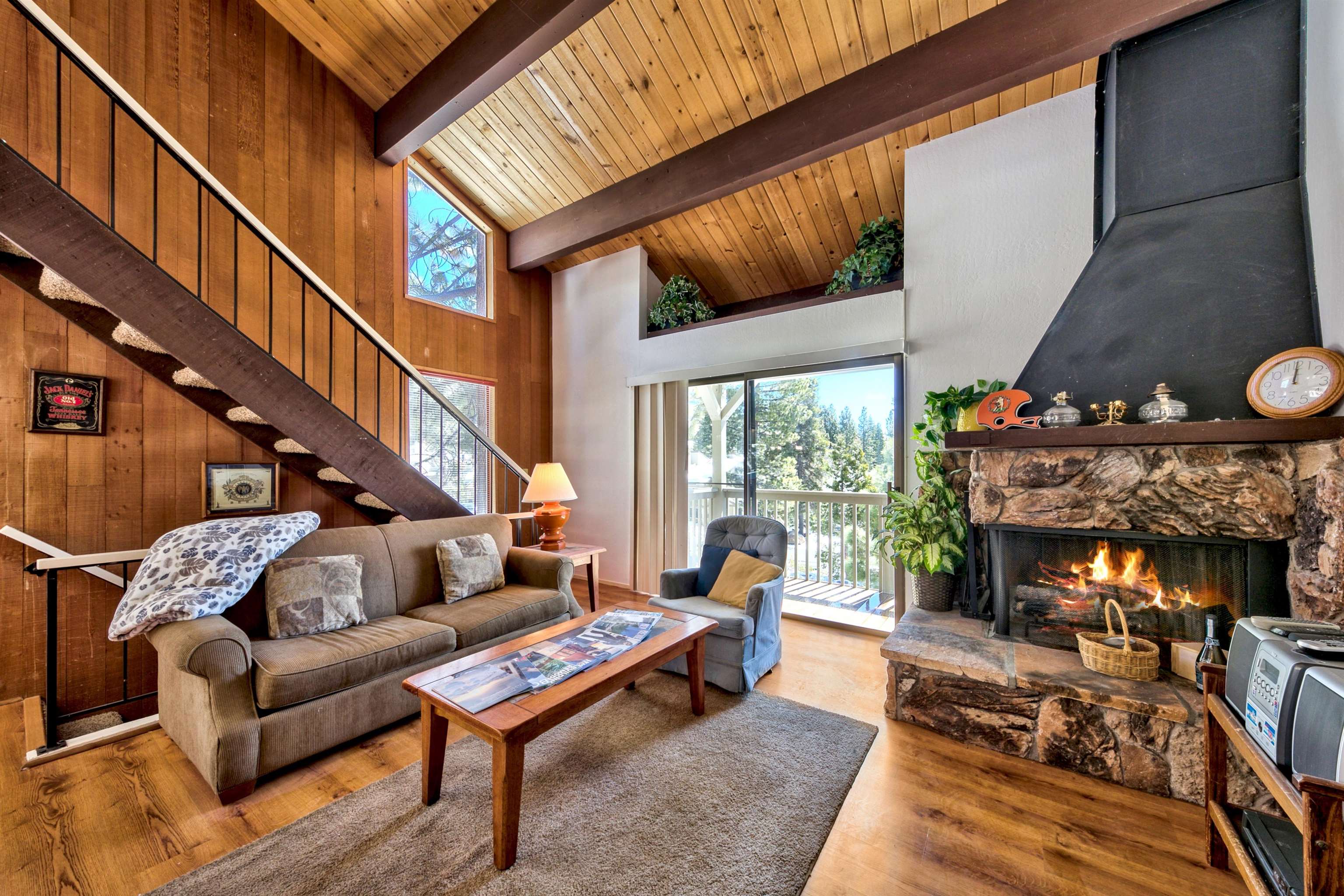a living room with furniture a fireplace and a large window