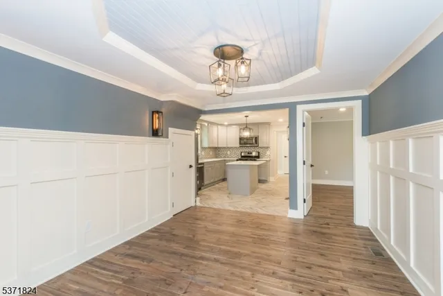 a view of a kitchen with wooden floor