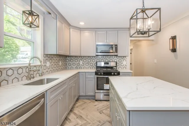 a kitchen with a sink a stove a microwave and cabinets