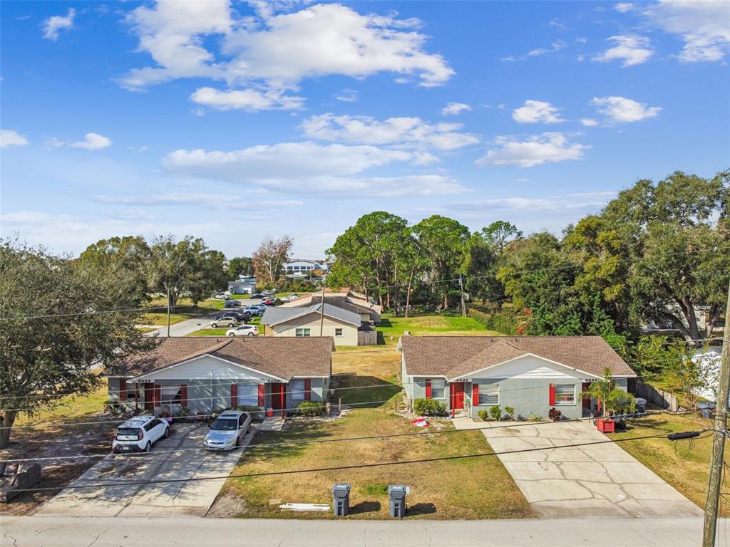 6026 Norton Road, Unit 6026 Lakeland, FL 33809 - Photo 2 of 17 a view of a swimming pool with a lawn chairs under an umbrella