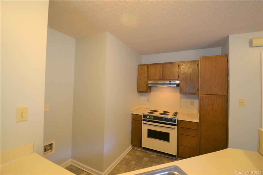 2343 Roland Drive, Unit F Monroe, NC 28110 - Photo 5 of 14 a kitchen with a stove and a cabinet