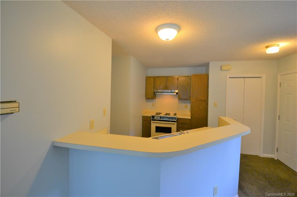 2343 Roland Drive, Unit F Monroe, NC 28110 - Photo 6 of 14 a kitchen with stainless steel appliances a refrigerator a stove a sink a chimney and wooden floor