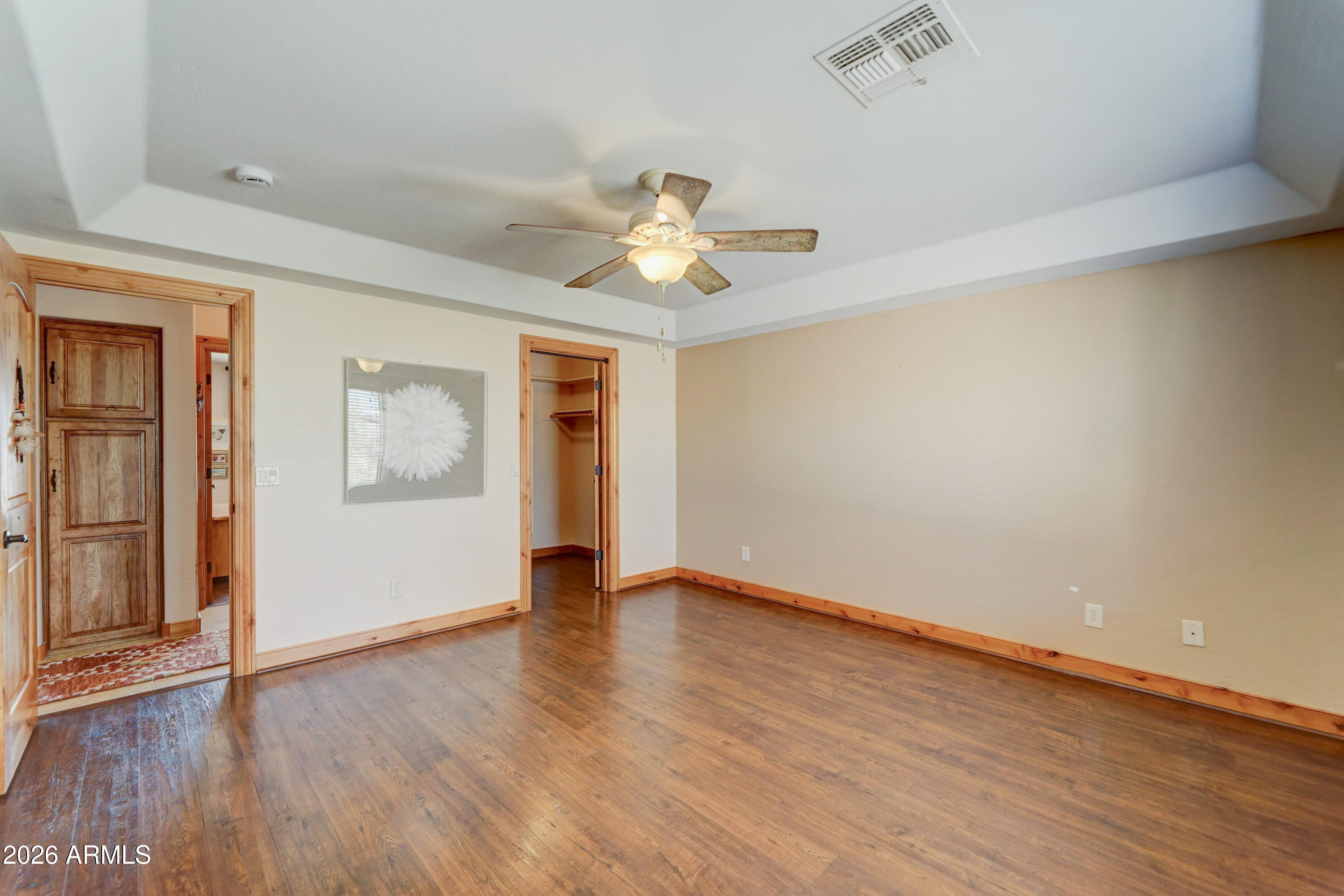 4642 North Tomahawk Road Apache Junction, AZ 85119 - Photo 14 of 41 a view of an empty room with window and wooden floor