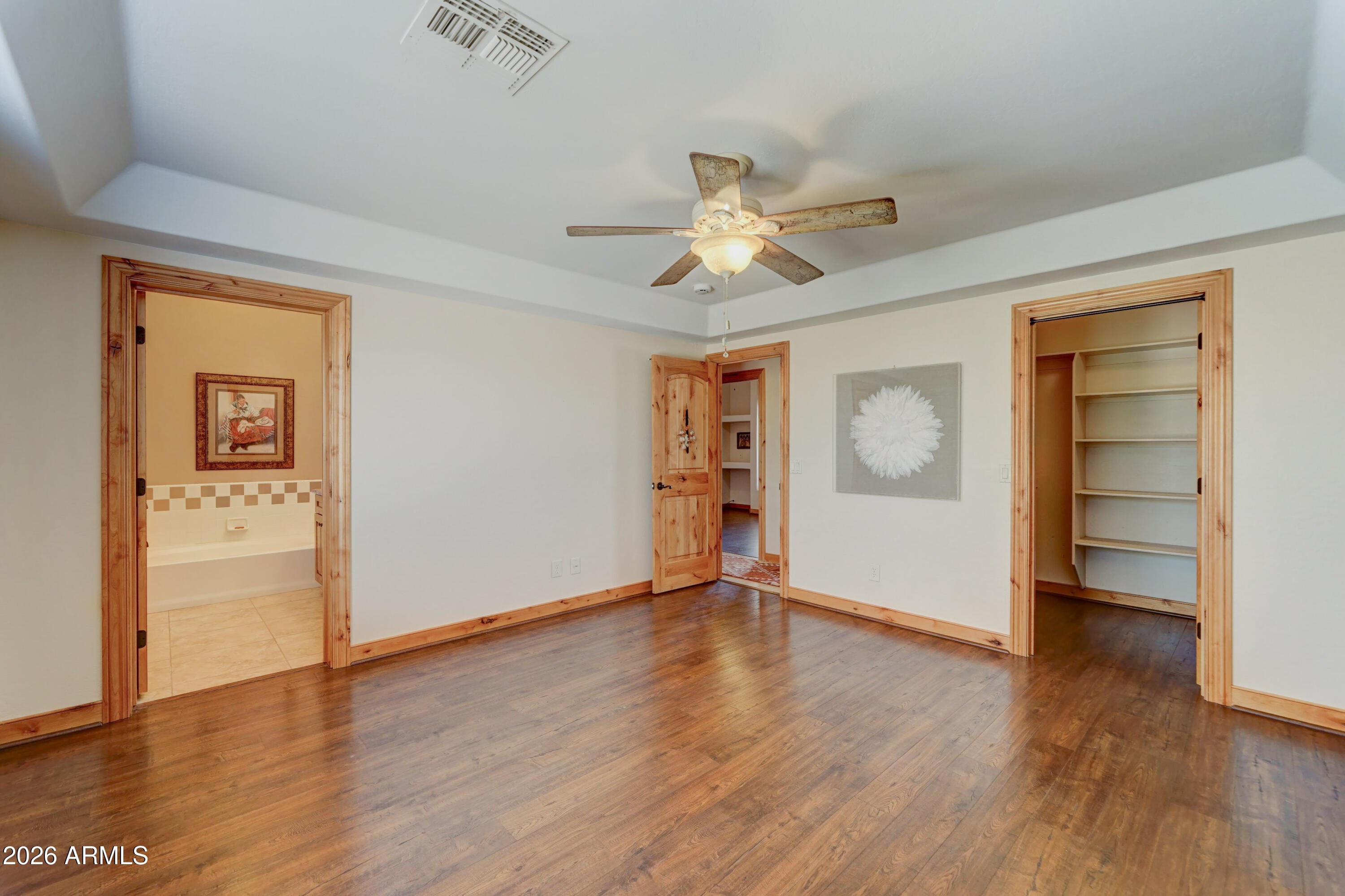 4642 North Tomahawk Road Apache Junction, AZ 85119 - Photo 15 of 41 an empty room with wooden floor closet and windows