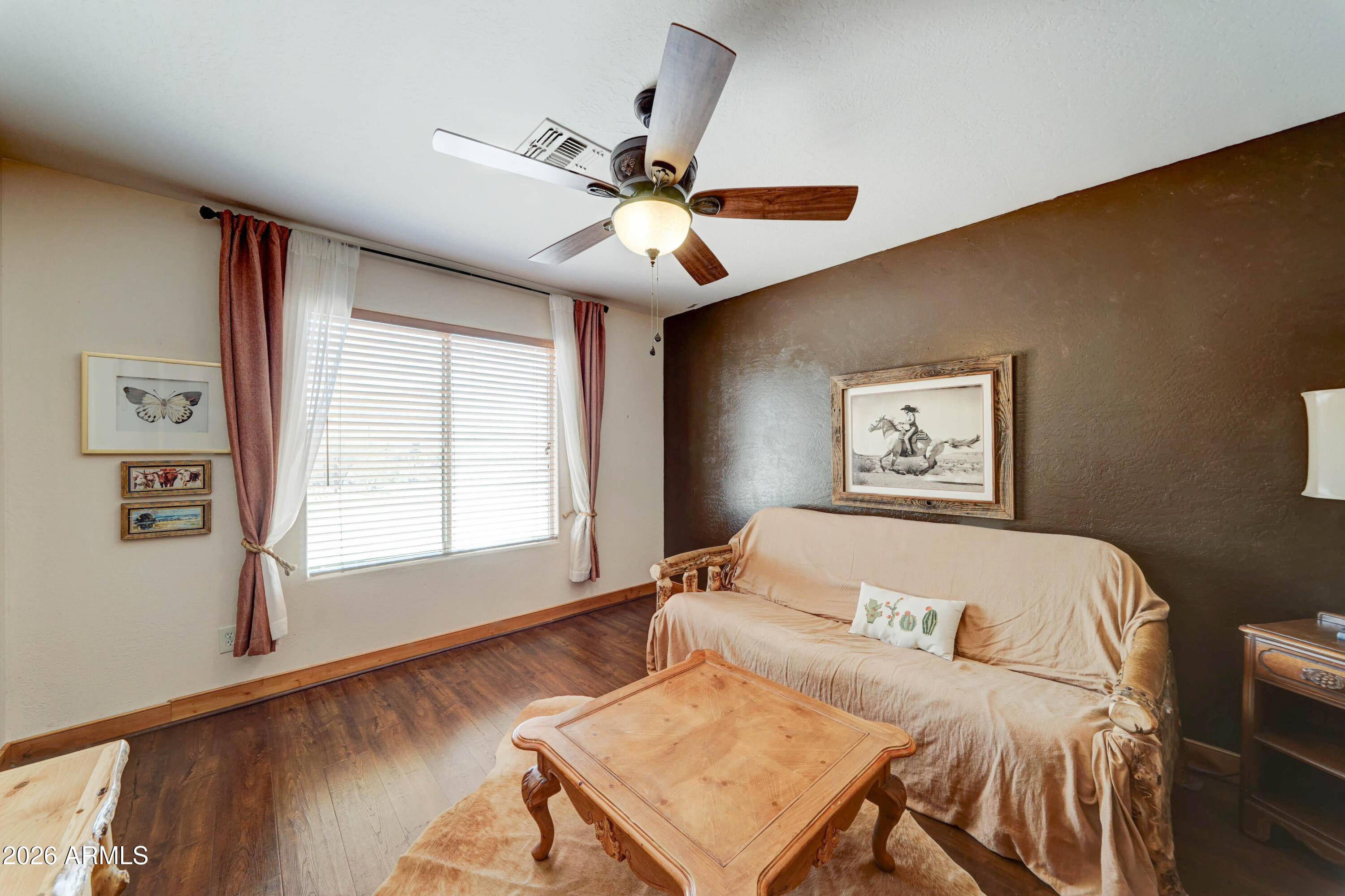 4642 North Tomahawk Road Apache Junction, AZ 85119 - Photo 19 of 41 a bedroom with a bed and a window