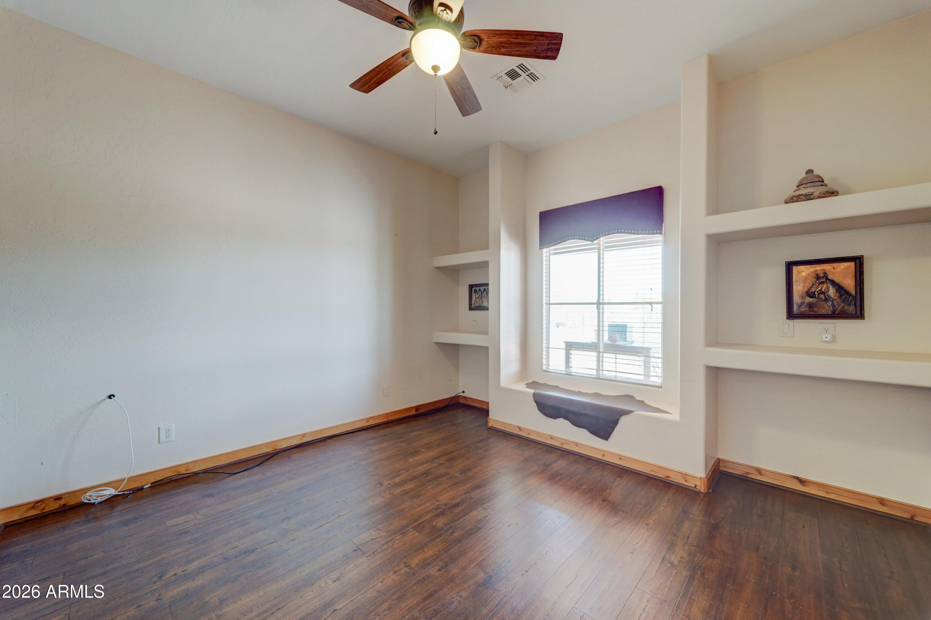 4642 North Tomahawk Road Apache Junction, AZ 85119 - Photo 20 of 41 wooden floor in an empty room with a window
