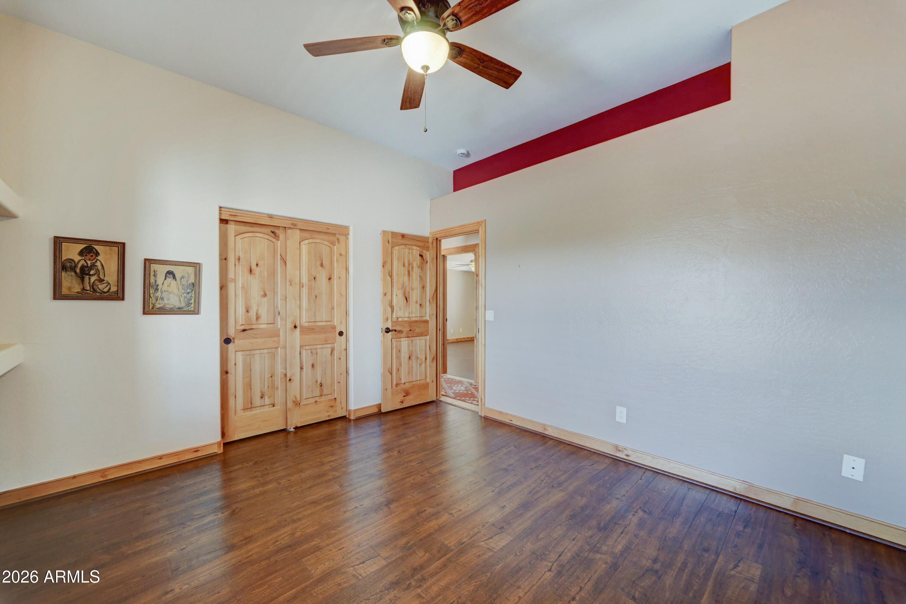 4642 North Tomahawk Road Apache Junction, AZ 85119 - Photo 23 of 41 a view of an empty room with wooden floor