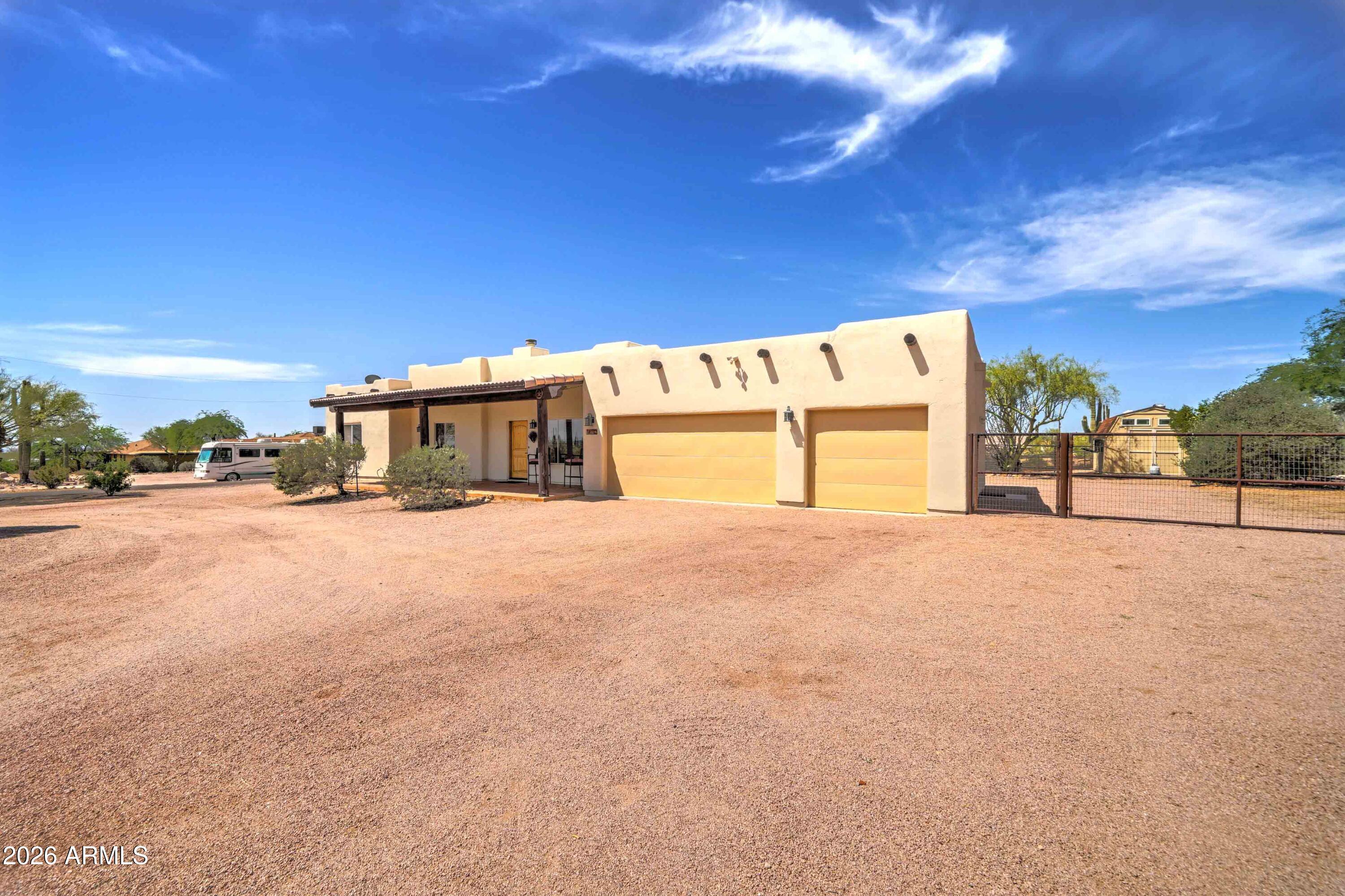 4642 North Tomahawk Road Apache Junction, AZ 85119 - Photo 40 of 41 a view of a house with a big yard and large trees