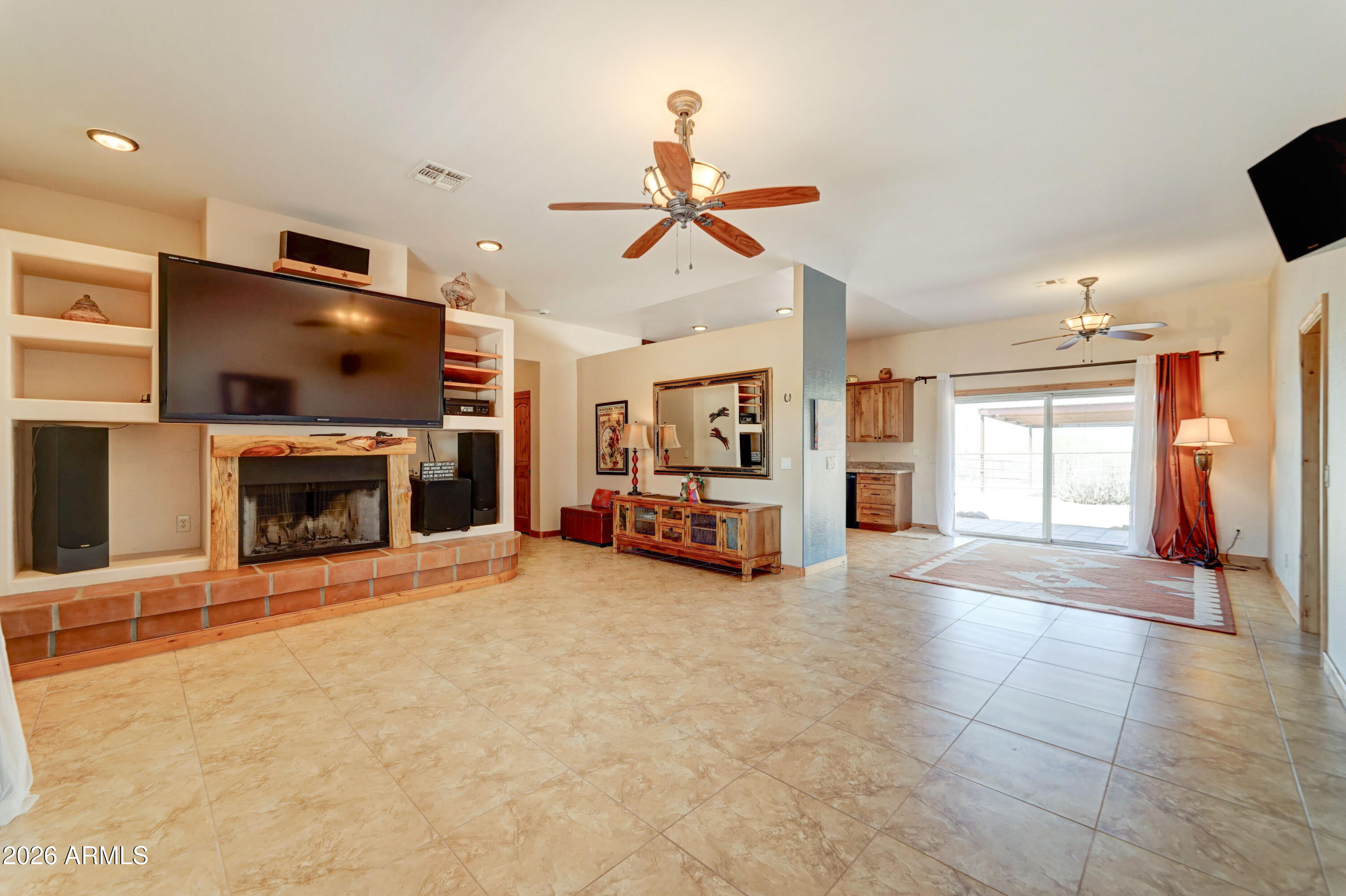4642 North Tomahawk Road Apache Junction, AZ 85119 - Photo 8 of 41 a view of a livingroom with a fireplace cabinet and a window