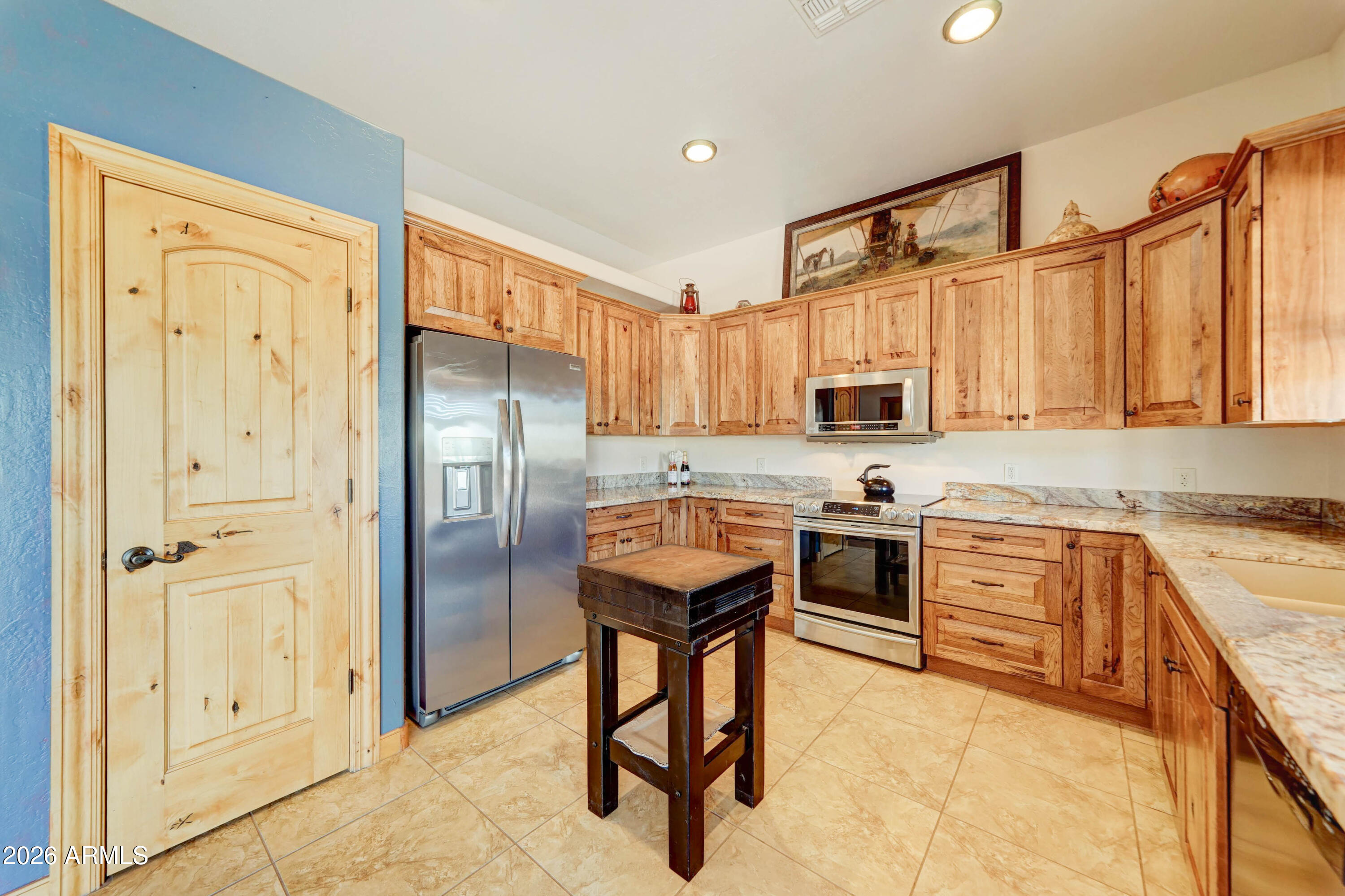 4642 North Tomahawk Road Apache Junction, AZ 85119 - Photo 10 of 41 a kitchen with stainless steel appliances granite countertop a refrigerator stove top oven and sink