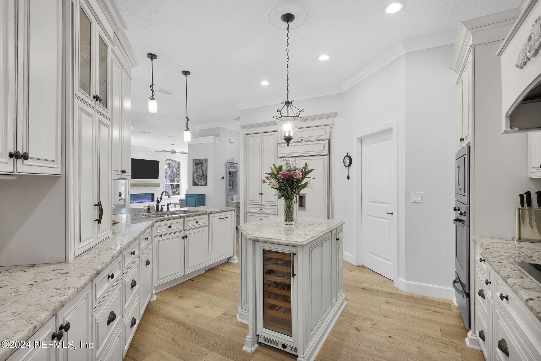 789 Mill Stream Road Ponte Vedra Beach, FL 32082 - Photo 15 of 46 a large kitchen with kitchen island granite countertop a stove a sink a refrigerator and white cabinets with wooden floor