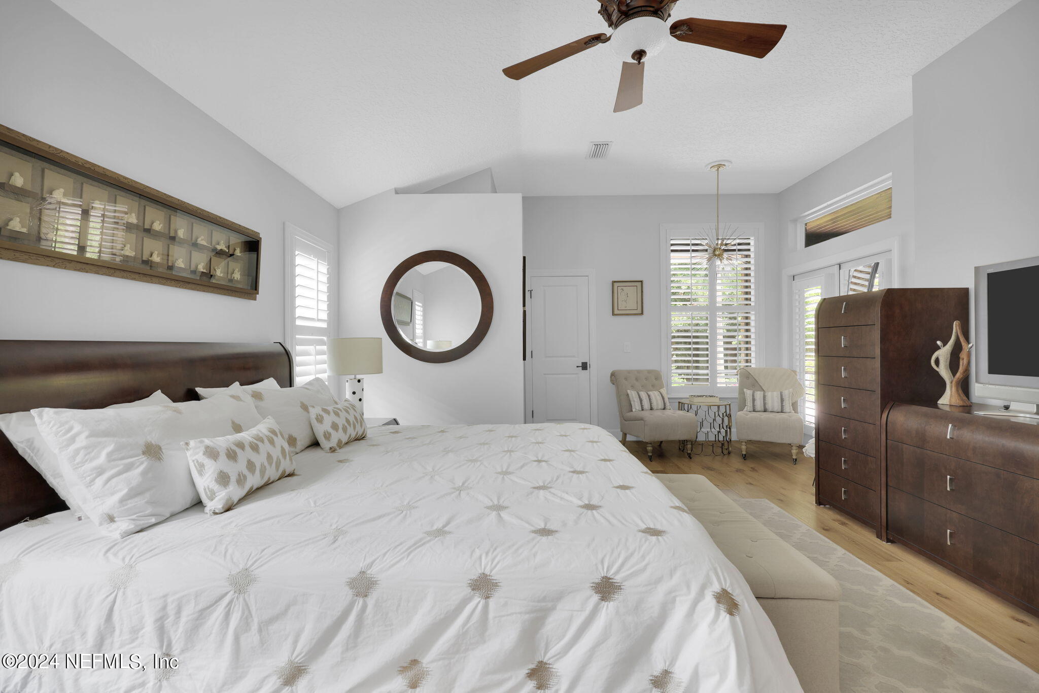 789 Mill Stream Road Ponte Vedra Beach, FL 32082 - Photo 21 of 46 a bedroom with a bed and a chandelier