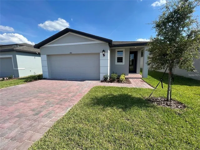 a front view of a house with a yard and porch
