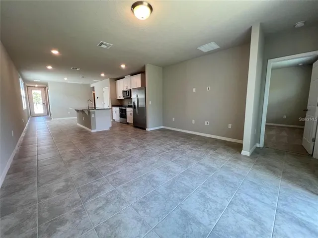a view of a kitchen with a sink and cabinets