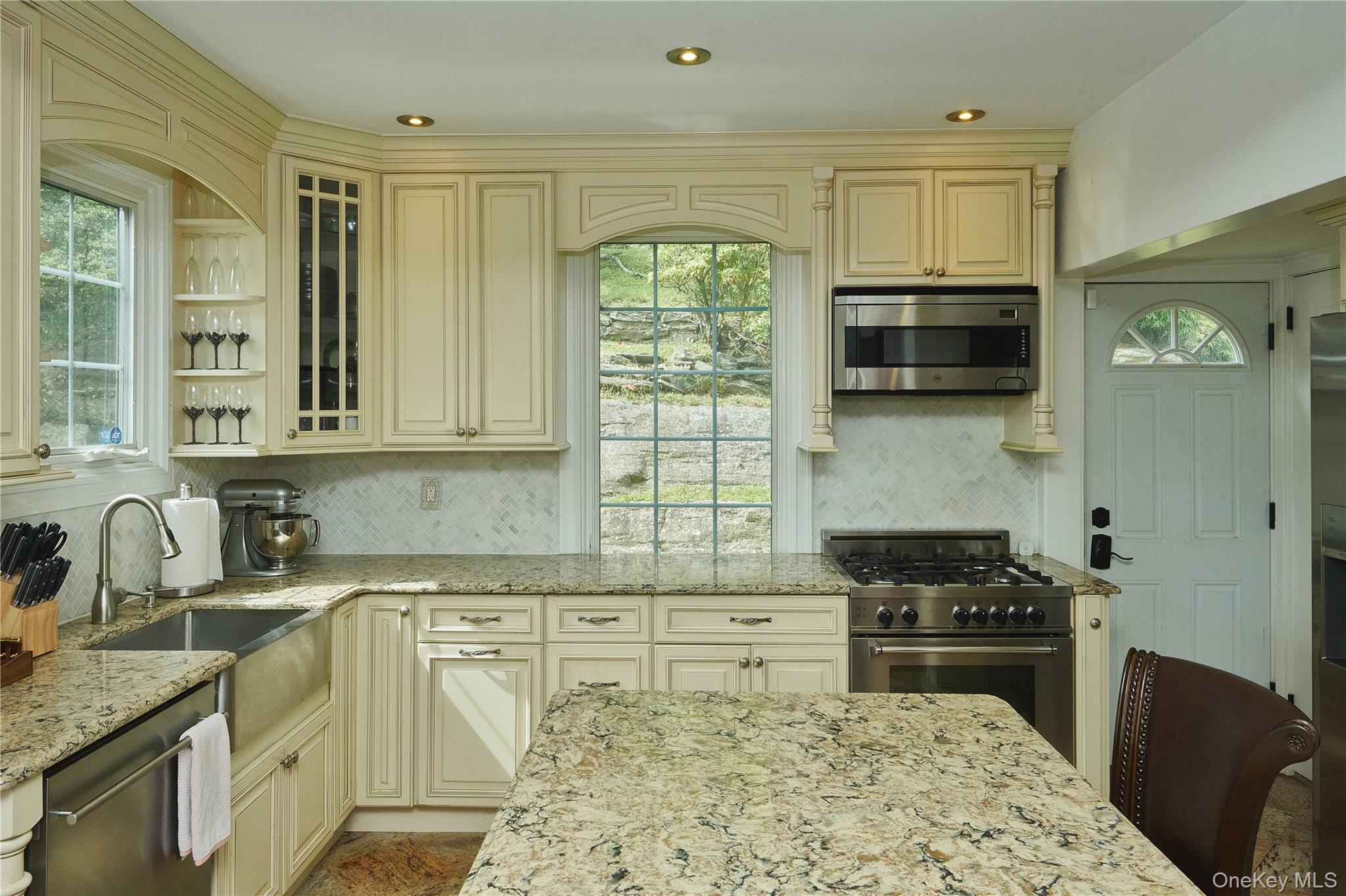 7 Avondale Road Yonkers, NY 10710 - Photo 11 of 36 a kitchen with stainless steel appliances granite countertop a sink stove and cabinets
