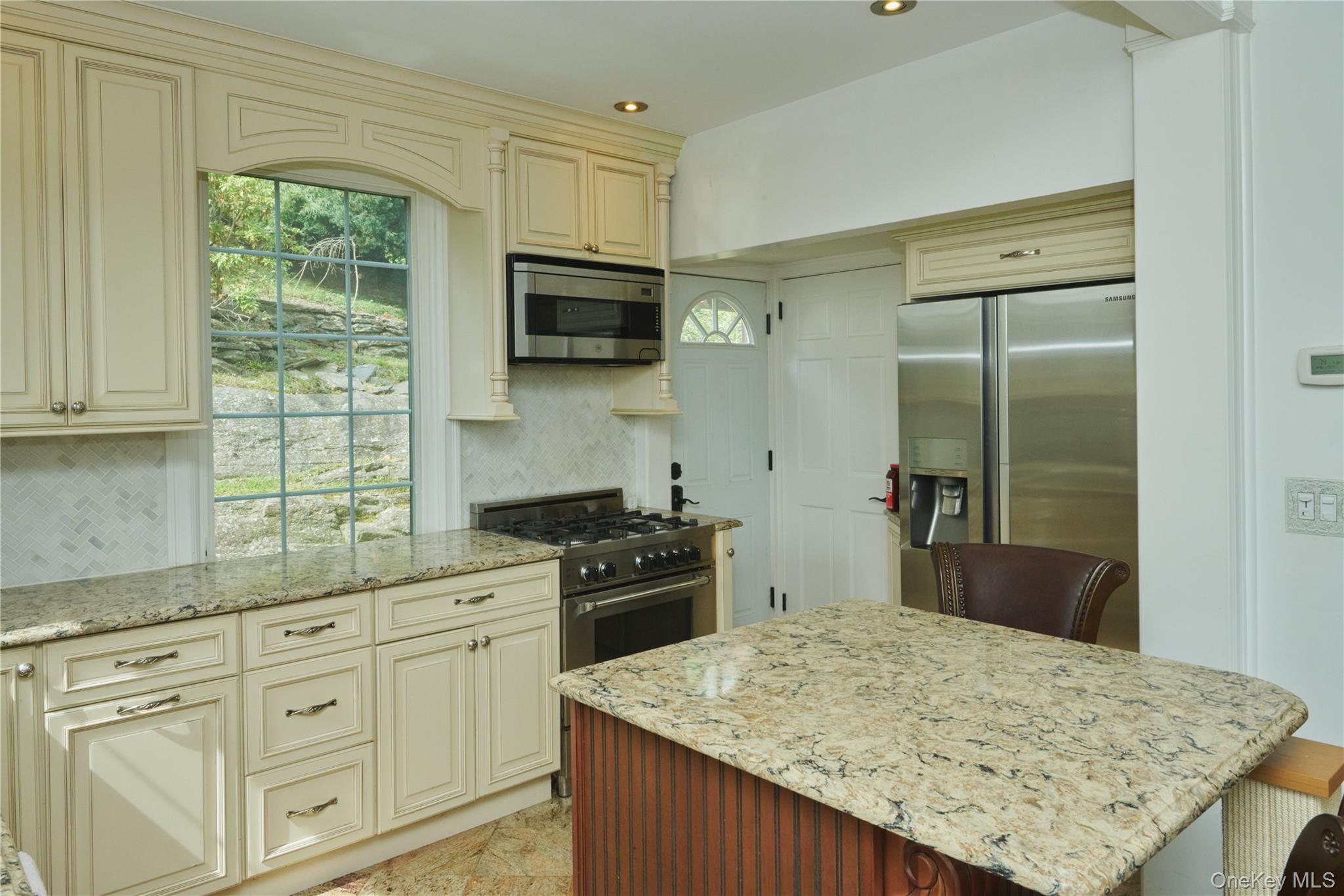 7 Avondale Road Yonkers, NY 10710 - Photo 10 of 36 a kitchen with kitchen island granite countertop a sink stove and refrigerator