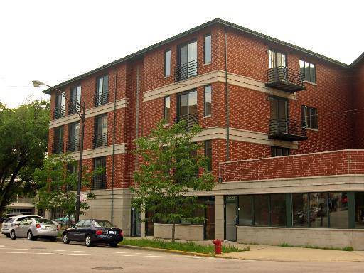 842 North Racine Avenue, Unit 202 Chicago, IL 60642 - Photo 1 of 25 a view of a car park in front of a building
