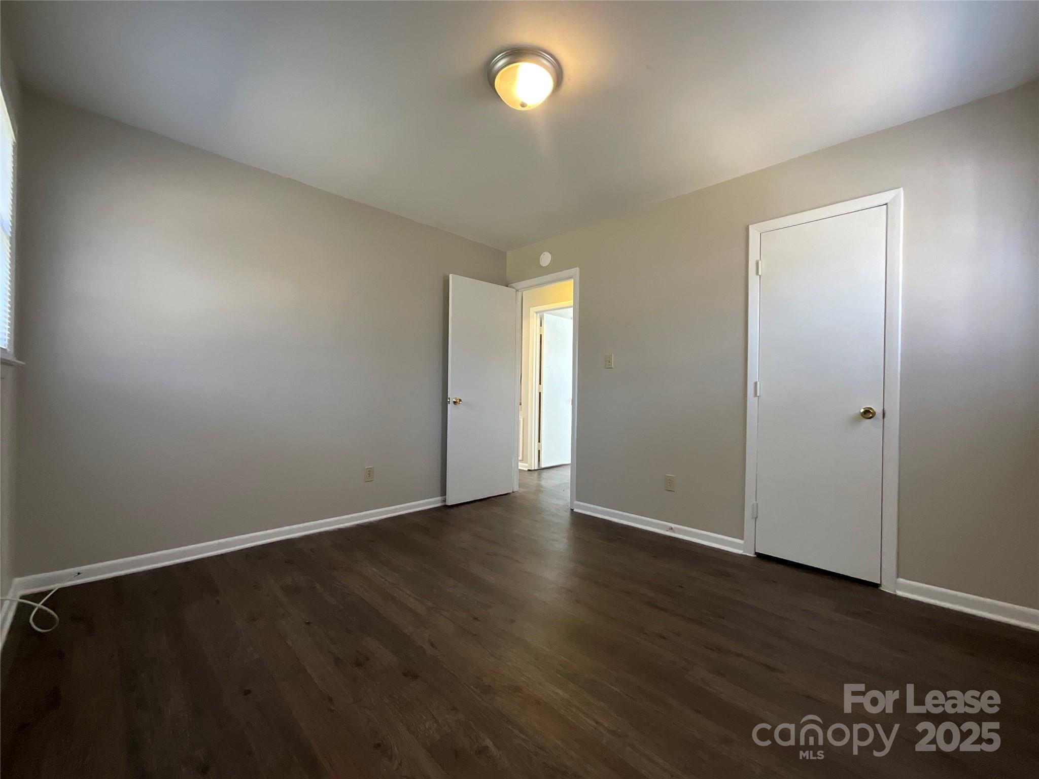 2002 Airport Road, Unit B Salisbury, NC 28147 - Photo 11 of 13 an empty room with wooden floor and windows