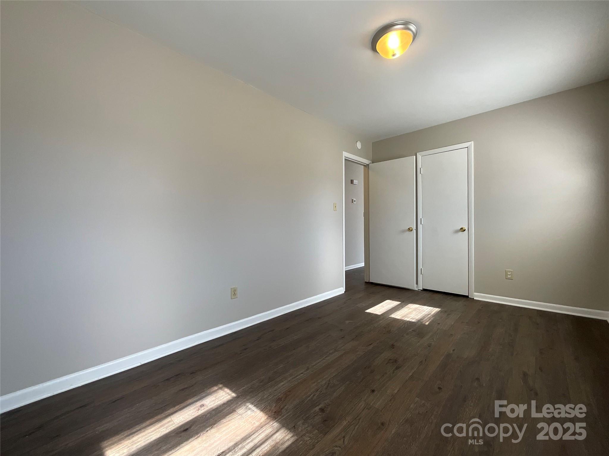 2002 Airport Road, Unit B Salisbury, NC 28147 - Photo 9 of 13 an empty room with wooden floor and a window