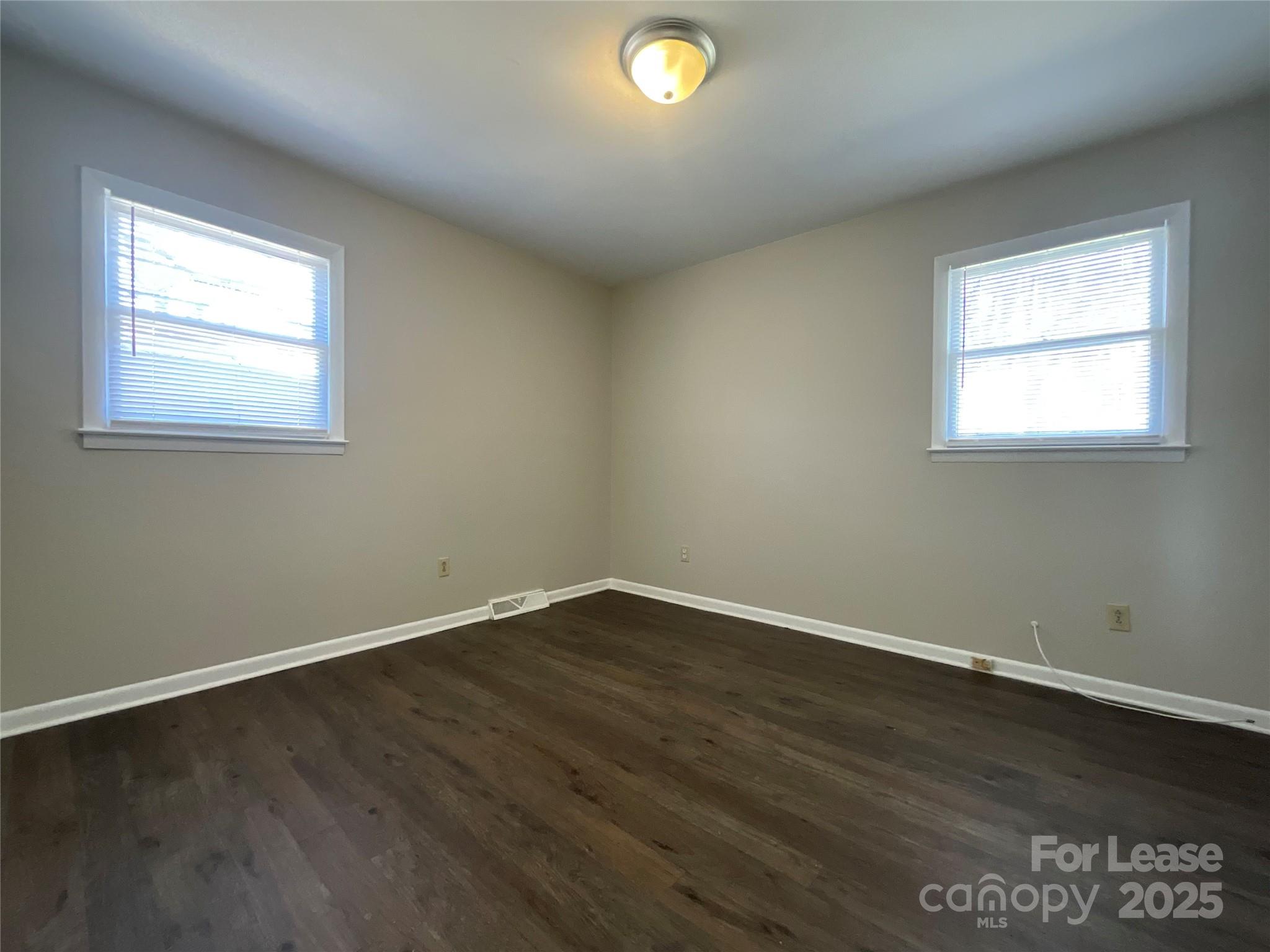 2002 Airport Road, Unit B Salisbury, NC 28147 - Photo 10 of 13 an empty room with wooden floor and windows