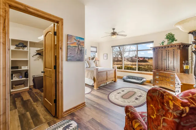 a bedroom with a bed and a large window with the outer view